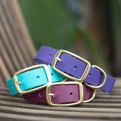 Leatherite dog collars made in australia. Stack of collars with name plates.
